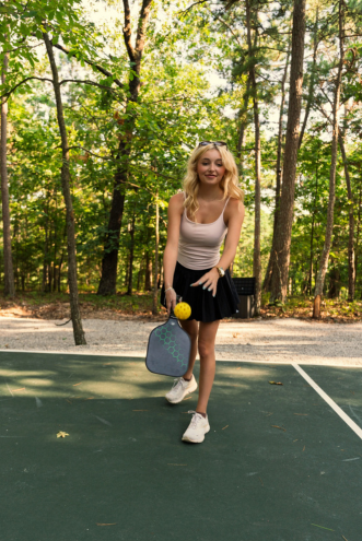Guest playing on the pickleball court tucked into the forest