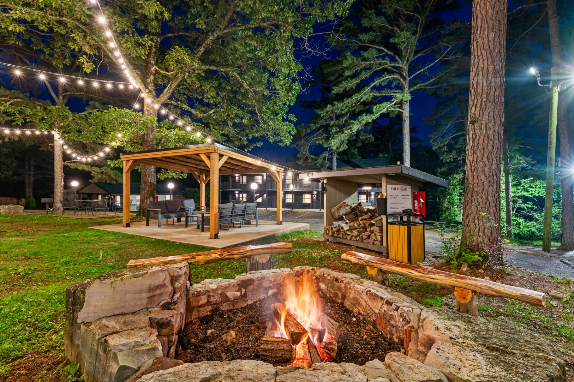 Fire pit gathering at night at Forest Springs Resort