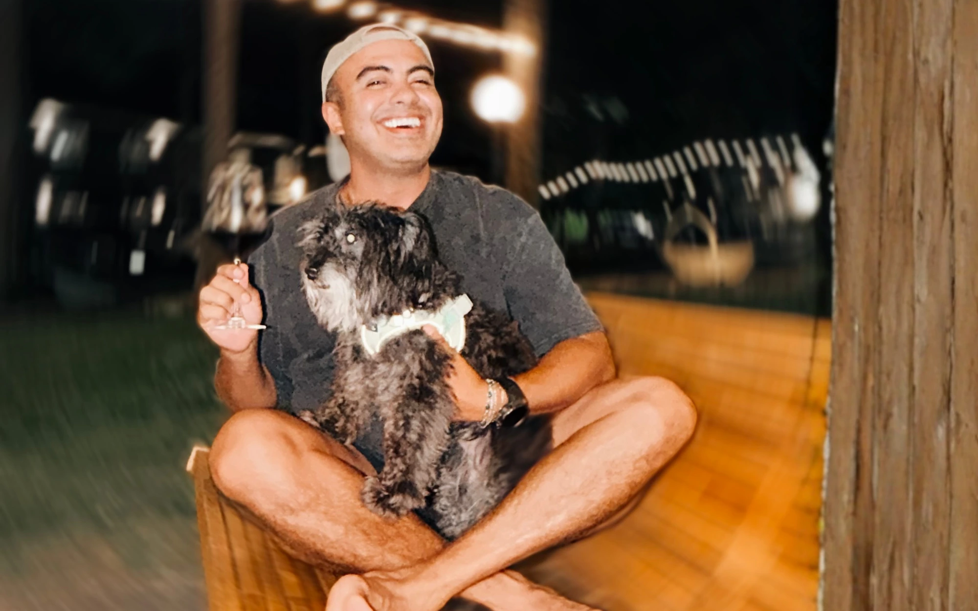 Guest hugging his dog at night on the deck at Forest Springs Resort