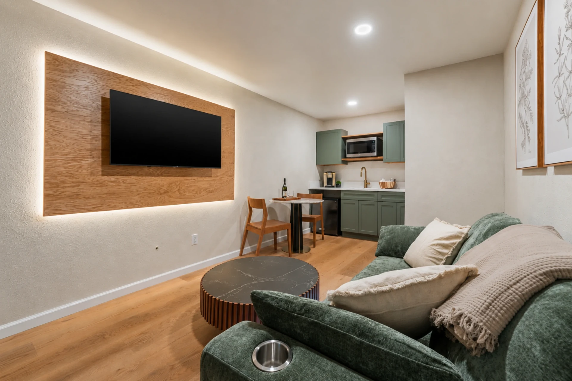 Cinema wall with backlit wood panel and kitchenette in the Intimate Suite