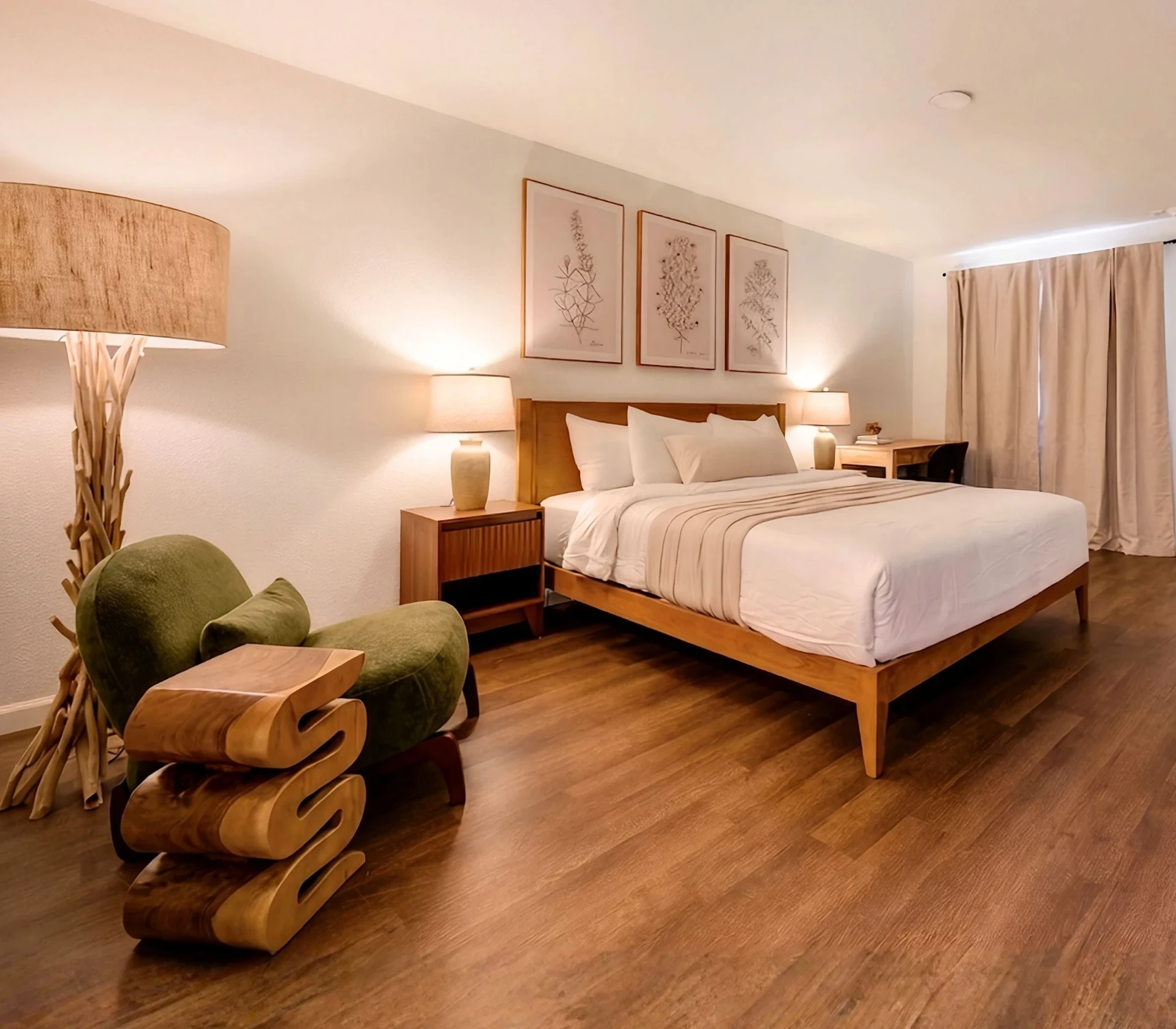King room with wood headboard, green armchair and botanical prints at Forest Springs Resort