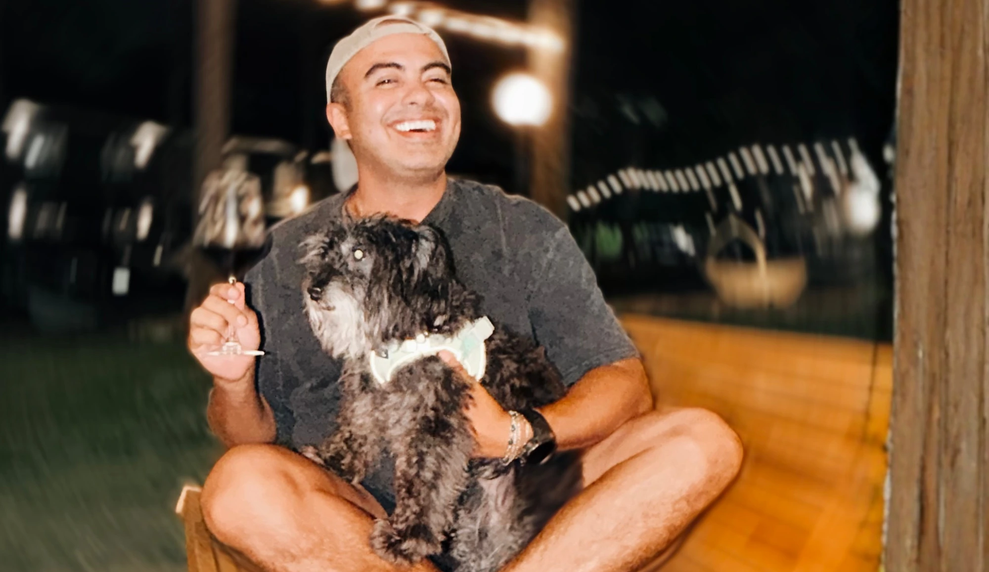 Guest laughing while holding his dog at the forest lounge